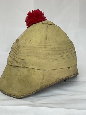 Lot 153 - A military pith helmet with red feather plume,...