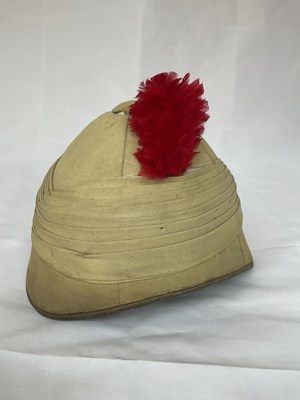 Lot 153 - A military pith helmet with red feather plume,...