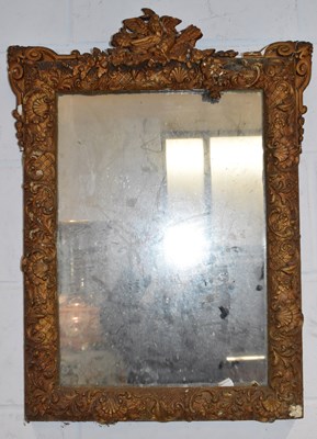 Lot 65 - An ornate gilt framed wall mirror, height 74cm.