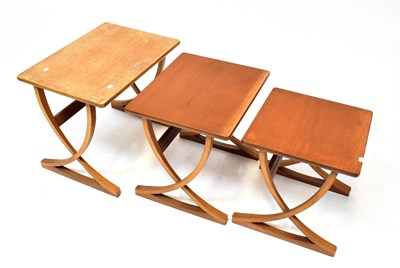 Lot 64 - A nest of three retro teak tables to curved...