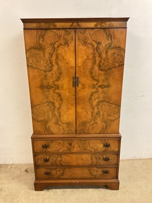 Lot 733 - A walnut two door cupboard over three drawers....