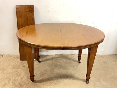 Lot 735 - An oval dining table with additional leaf....
