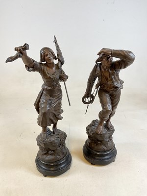 Lot 210 - A pair of male and female spelter figures.