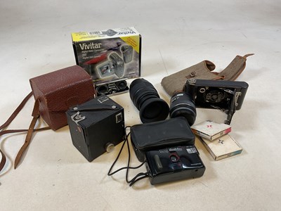 Lot 44 - A Kodak folding camera, a cased Box Brownie, a...