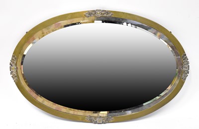 Lot 87 - An oval brass framed mirror with applied...