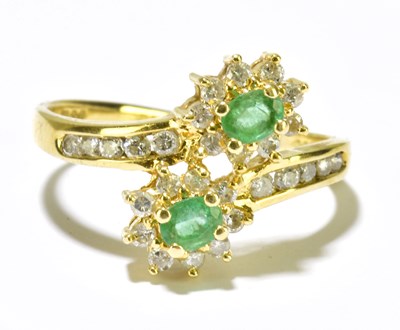 Lot 62 - An 18ct yellow gold emerald and diamond...