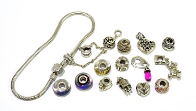 Lot 390 - A snake link bracelet with a quantity of charms.
