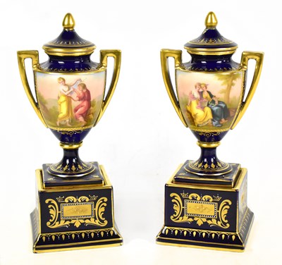 Lot 441 - VIENNA; a pair of late 19th century twin handled hand painted pedestal urn vases