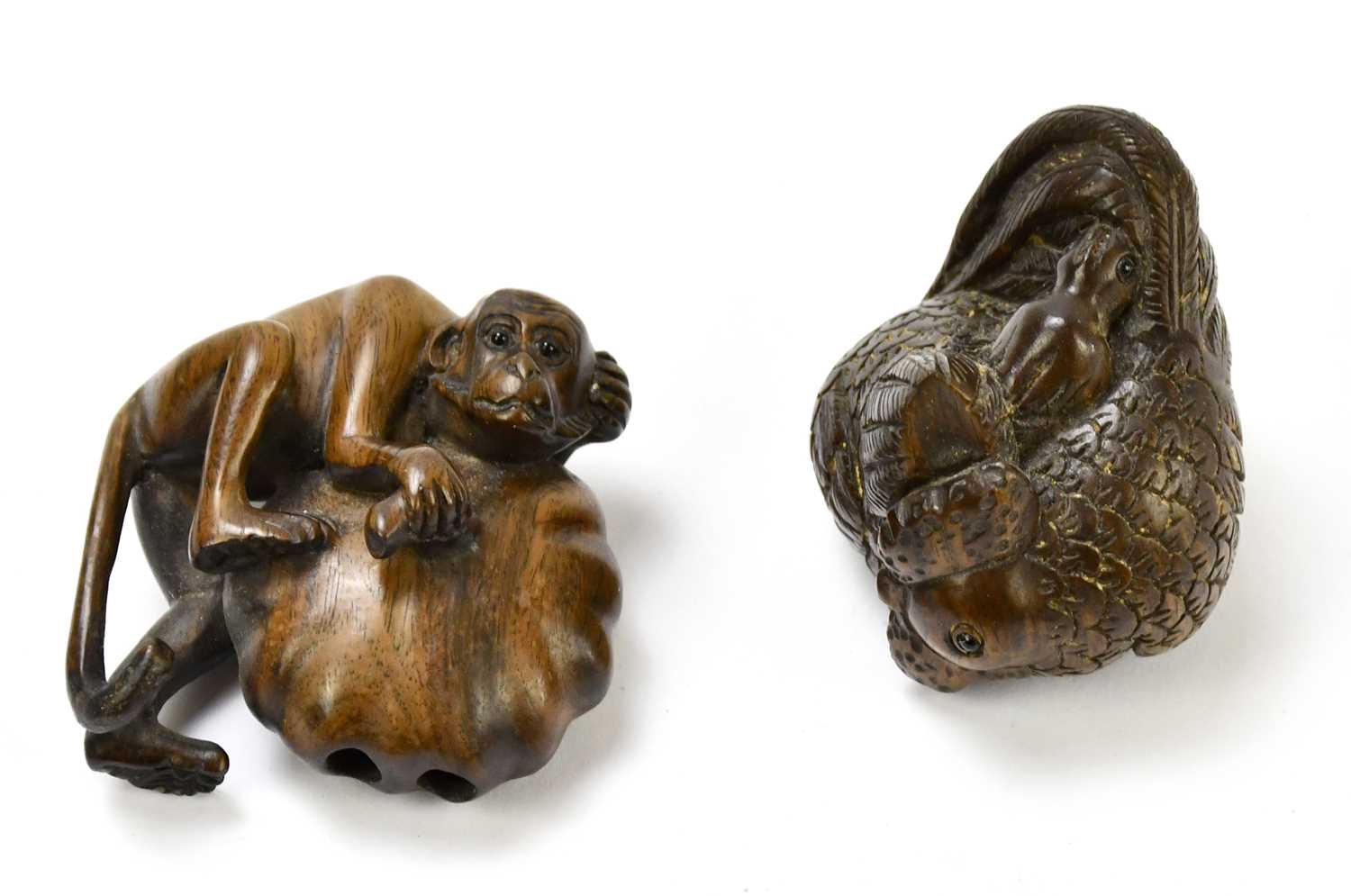 Lot 2288 - Two contemporary carved wooden netsuke, one...