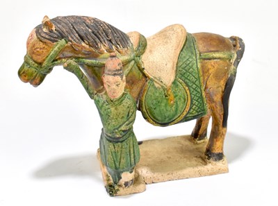 Lot 1025 - A Chinese Tang dynasty (218-906AD) Sancai glazed model of a horse