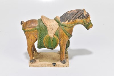 Lot 1025 - A Chinese Tang dynasty (218-906AD) Sancai glazed model of a horse