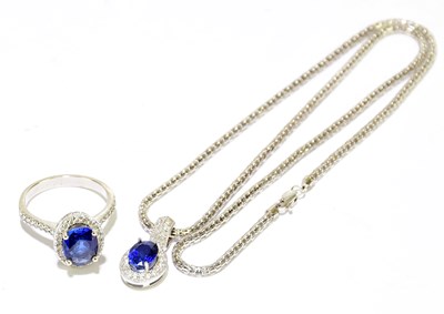 Lot 1450 - An 18ct white gold and tanzanite pendant and...