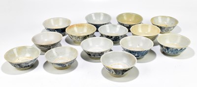 Lot 1021 - Fourteen similar Chinese Tek Sing Cargo blue and white painted Celadon bowls.