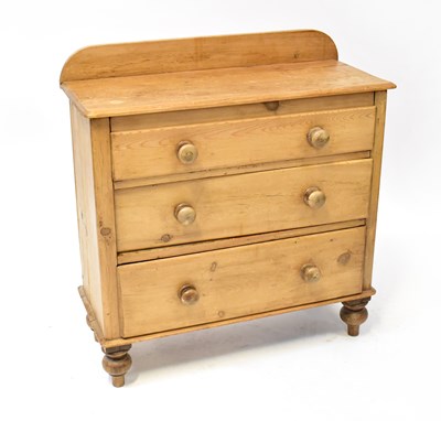 Lot 38 - A pine chest of three graduated drawers,...