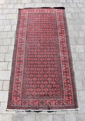 Lot 88 - A Kayam red ground rug, 204 x 103cm.