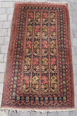 Lot 91 - An early 20th century Iranian red ground rug,...