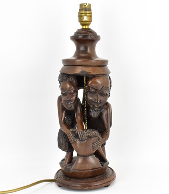 Lot 99 - An early 20th century carved wood table lamp...