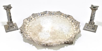 Lot 1049 - A silver plated shaped circular tray raised on three scrolling supports