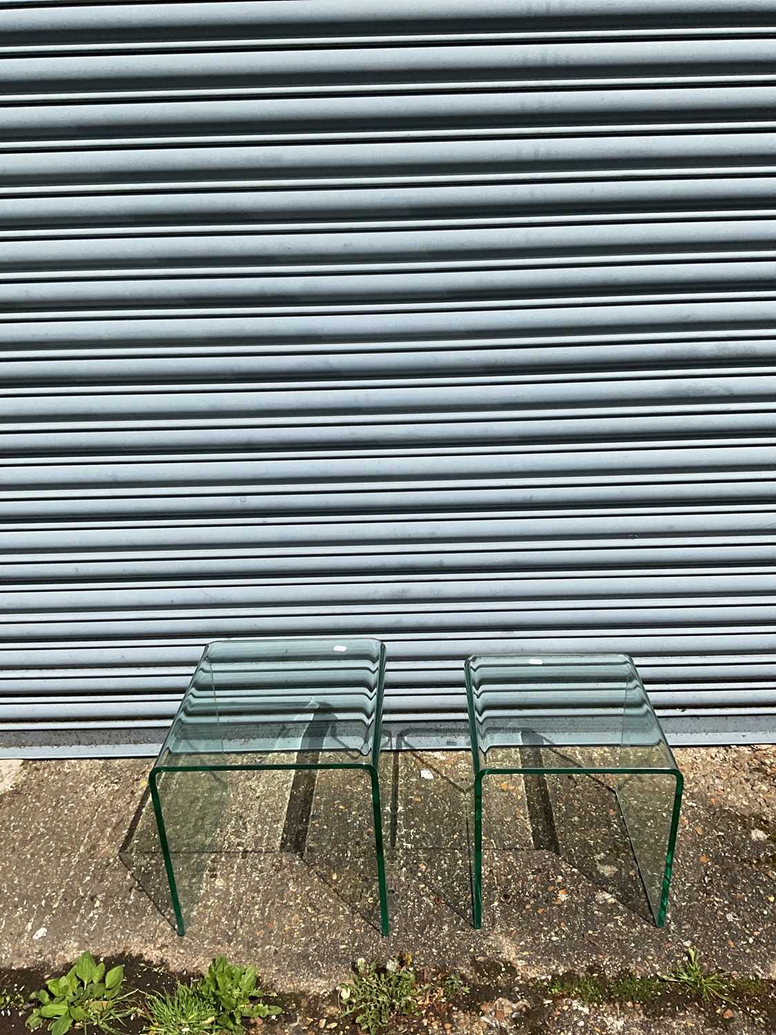 Lot 138 Two modern curved glass occasional tables,