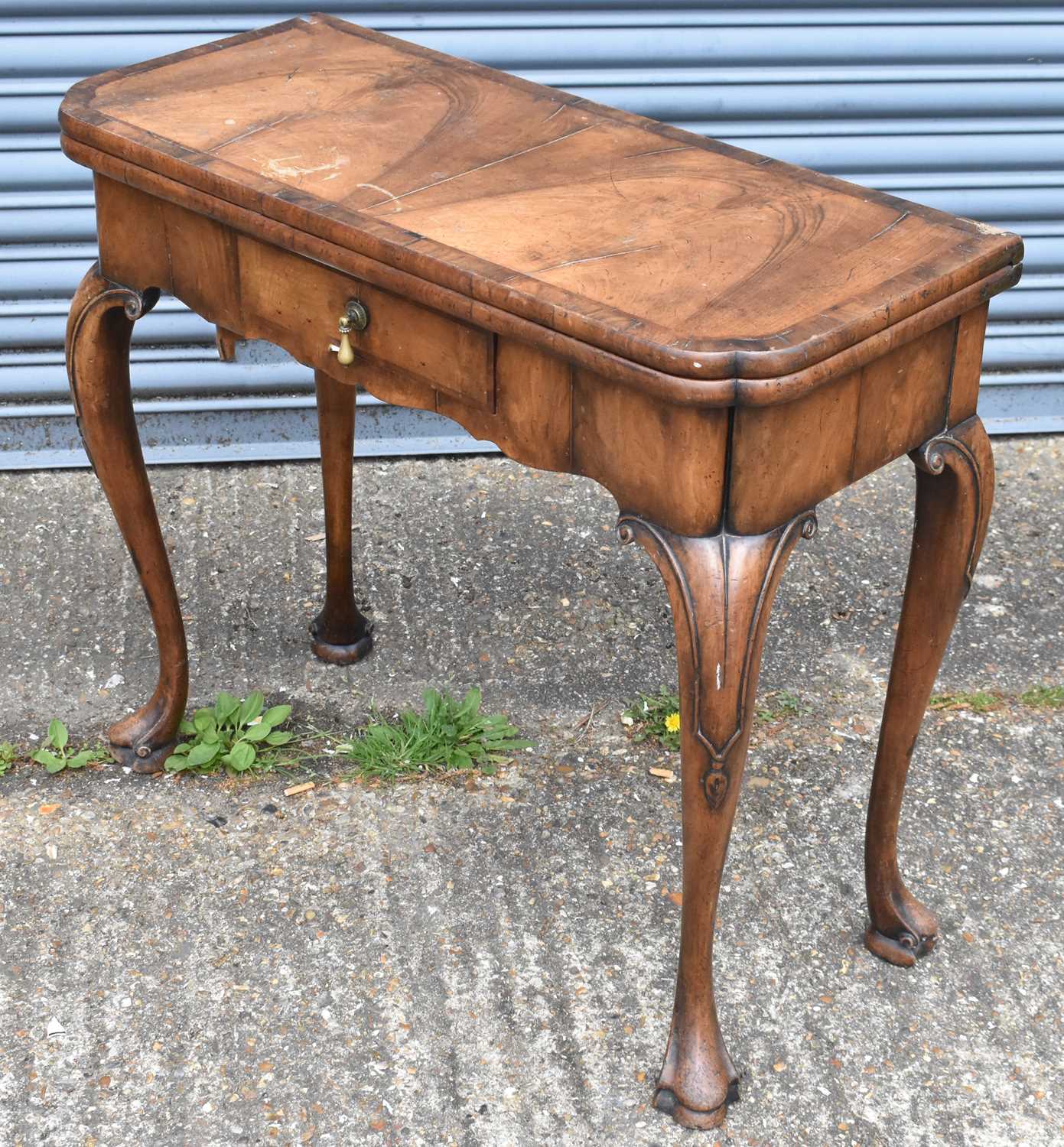 Lot 12 - An 18th century walnut card table, with...