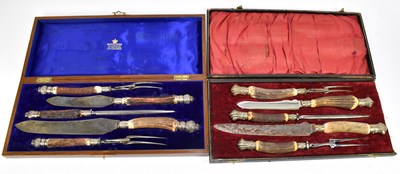 Lot 1050 - A cased five piece antler handled carving set and a similar oak cased example