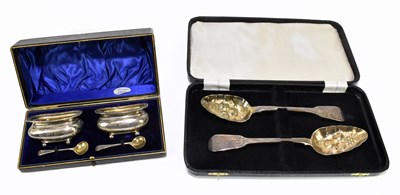 Lot 1076 - A pair of George III hallmarked silver Fiddle pattern and later 'berry' decorated spoons