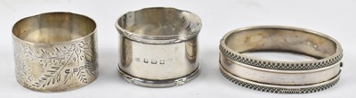 Lot 831 - Two hallmarked silver napkin rings and a white...
