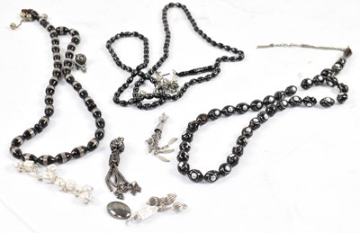 Lot 877 - Three hardstone islamic bead necklaces with...