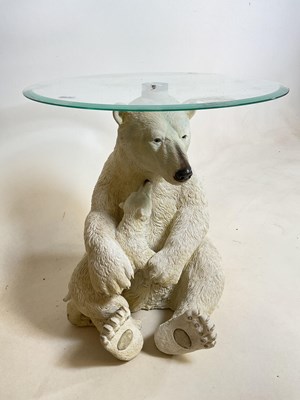 Lot 739 - A glass topped table featuring a polar bear...