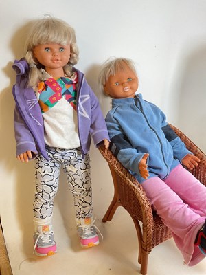 Lot 130 - A pair of lifesize dolls and a chair