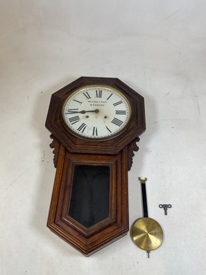 Lot 407 - An oak wall clock with octagonal case and...