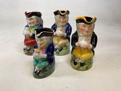 Lot 236 - Four 19th century Staffordshire Toby jugs,...