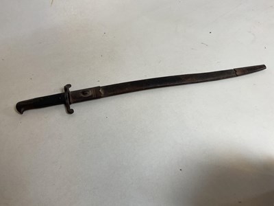 Lot 143 - A bayonet in scabbard with textured grip, and...