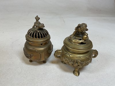 Lot 275 - Two brass three legged censers with covers,...