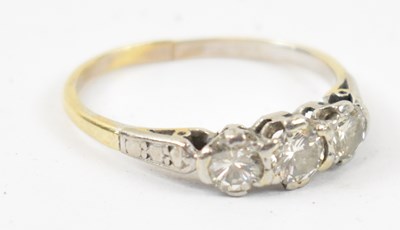 Lot 893 - A yellow metal engagement ring, set with three...