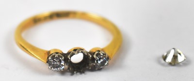 Lot 885 - An 18ct yellow gold three stone ring, set with...