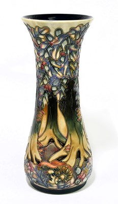 Lot 46 - MOORCROFT; a tall vase decorated with a...