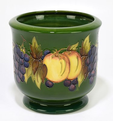 Lot 37 - MOORCROFT; a jardinière decorated with fruits...