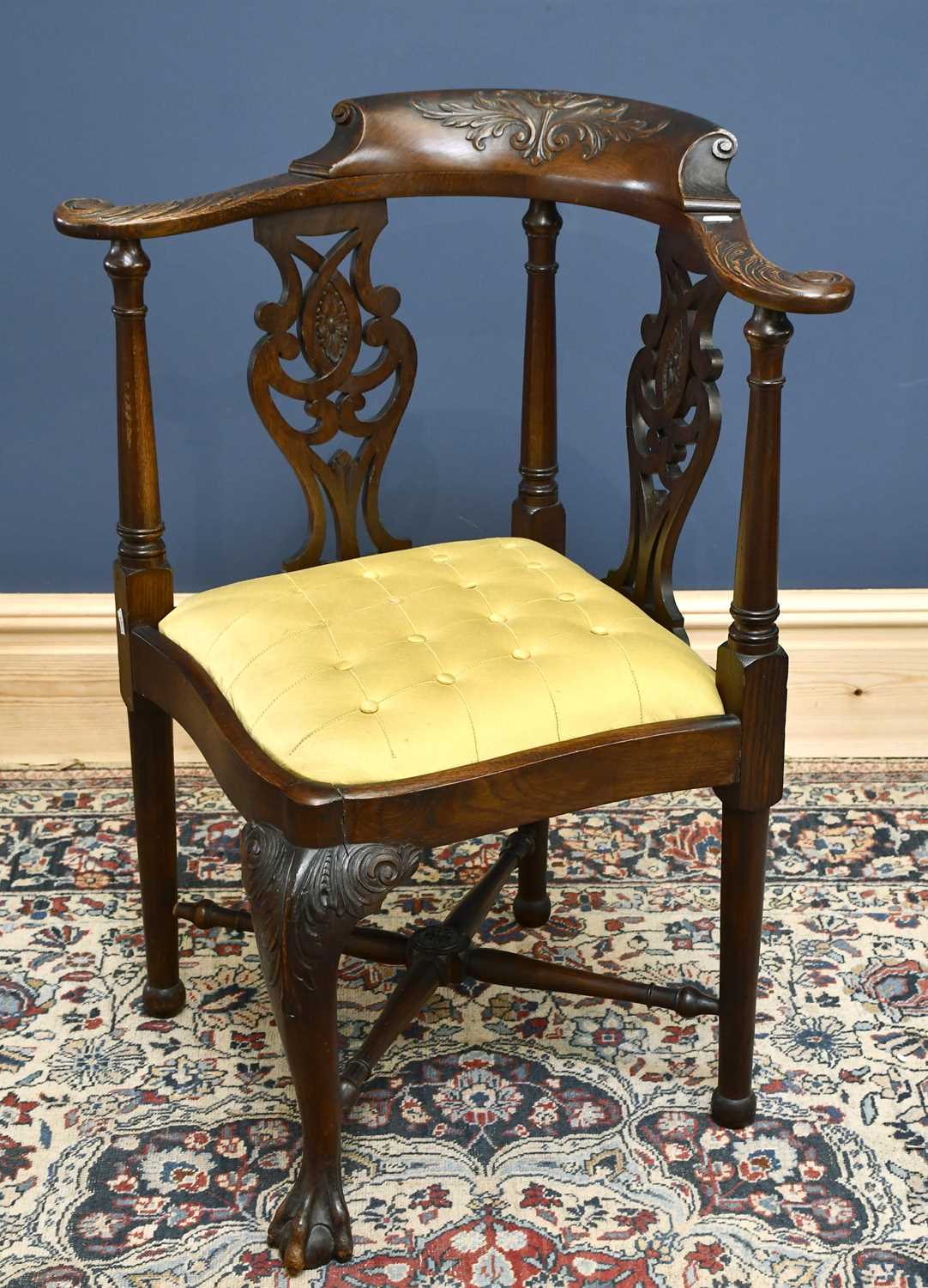 Lot 2885 - A carved oak corner chair with pierced sides...