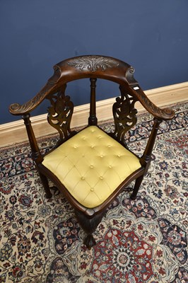 Lot 2885 - A carved oak corner chair with pierced sides...