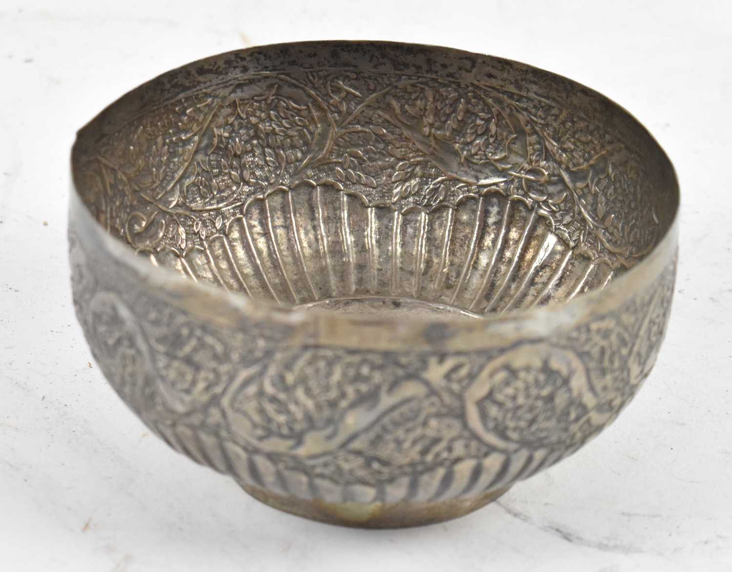 Lot 575 - An Eastern white metal bowl with embossed