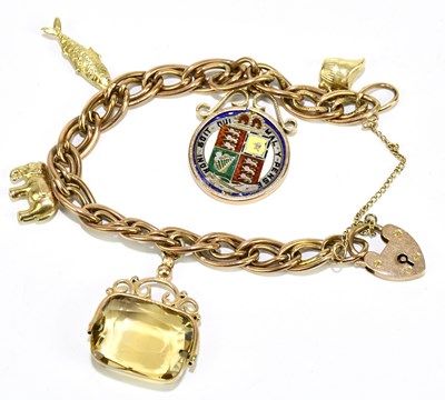 Lot 1435 - A 9ct yellow gold charm bracelet suspending an...