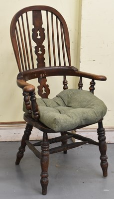 Lot 63 - A reproduction oak Winsor type elbow chair.