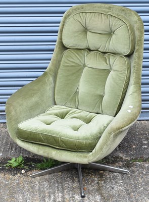 Lot 100 - A 20th century green upholstered egg chair.