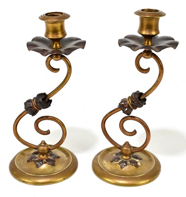 Lot 349 - A pair of Arts and Crafts brass and copper candlesticks