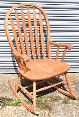 Lot 128 - A modern light oak rocking chair.