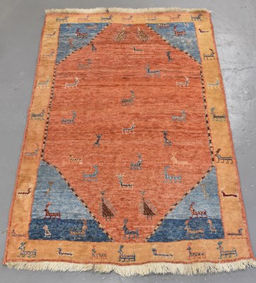 Lot 187 - A modern reg ground rug decorated with animals.