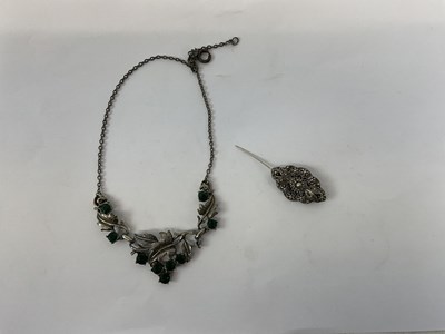 Lot 936 - A white metal necklace set with green stones...