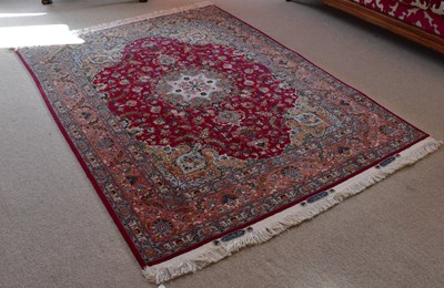Lot 2726 - NATIONAL IRANIAN CARPETS; a red ground rug...