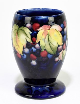 Lot 24 - MOORCROFT; a 'Leaf and Berry' pattern vase,...